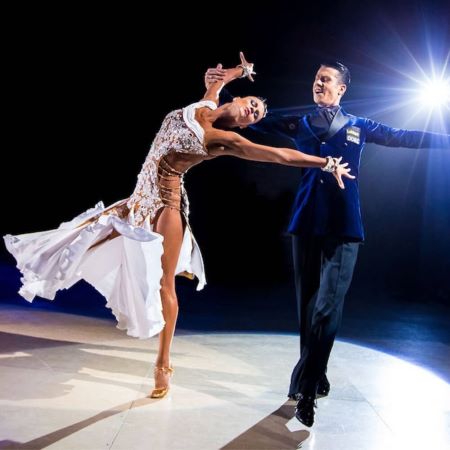 A champion ballroom dance couple performing an exhibition Foxtrot.