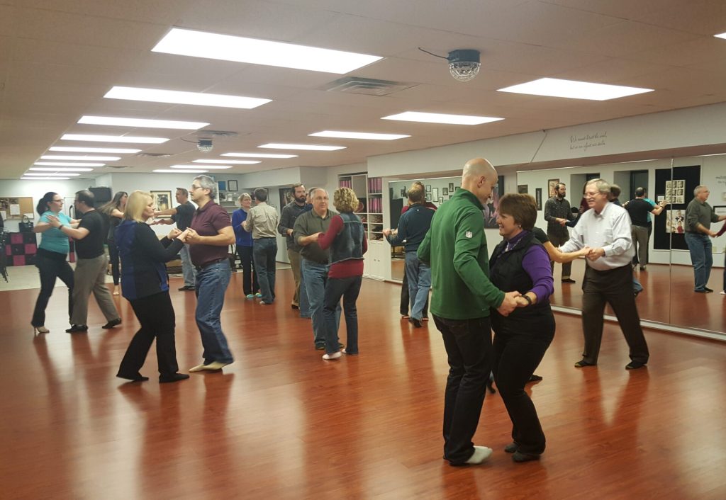 Ballroom dancing group class of 10 couples.