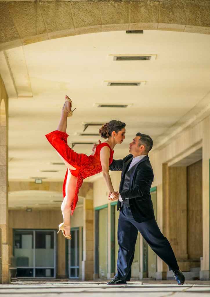 A female ballroom dancer is being lifted by her partner in an exciting move.