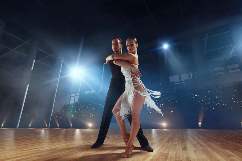 A ballroom dancesport couple performing Latin routine.
