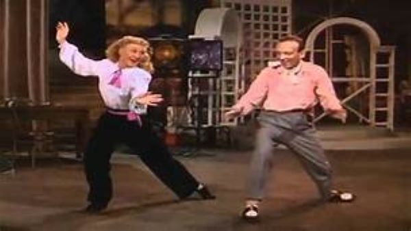 Ginger Rogers and Fred Astaire Dancing side by side.